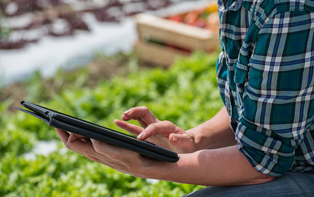 Female gardener with digital tablet.